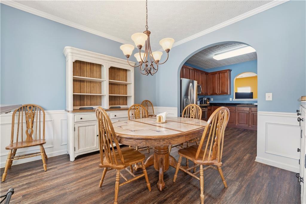 2708 Oakmont Way Monroe, GA 30656 - Photo 6 of 40 a view of a dining room with furniture and a chandelier