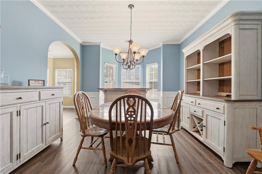 2708 Oakmont Way Monroe, GA 30656 - Photo 7 of 40 a view of a dining room with furniture window and wooden floor