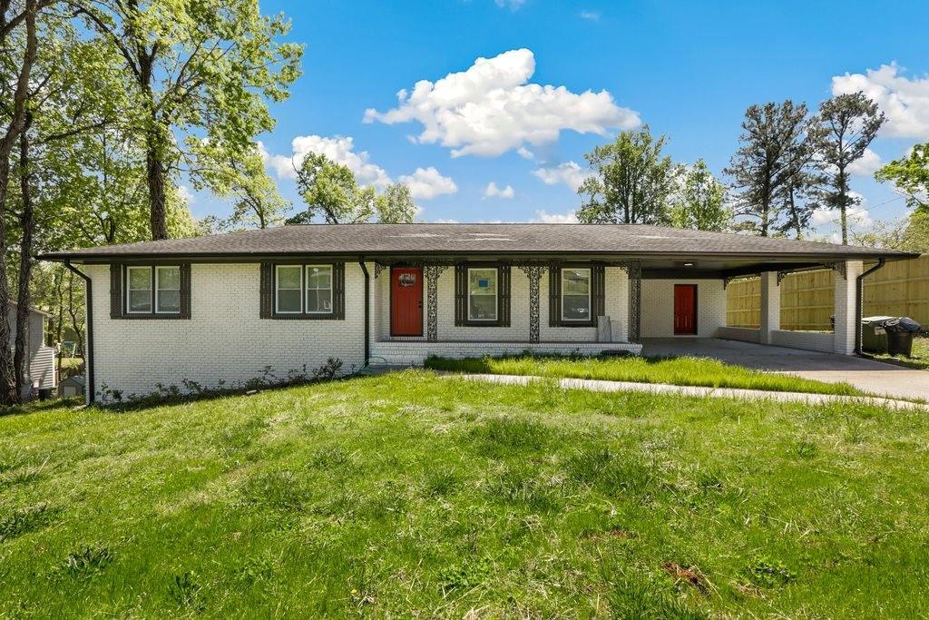 a view of a house with a backyard