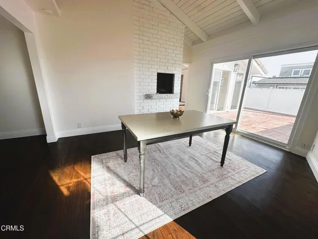 a view of a workspace with furniture and wooden floor