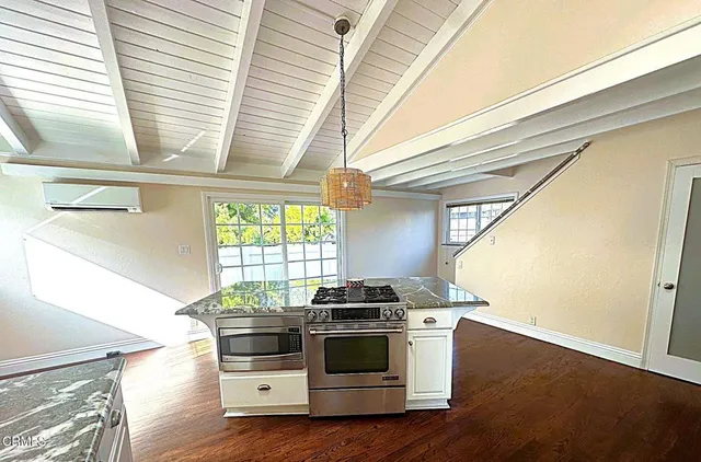 a kitchen with a stove and a window