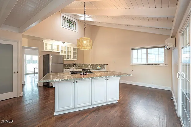 a kitchen with a sink cabinets and wooden floor