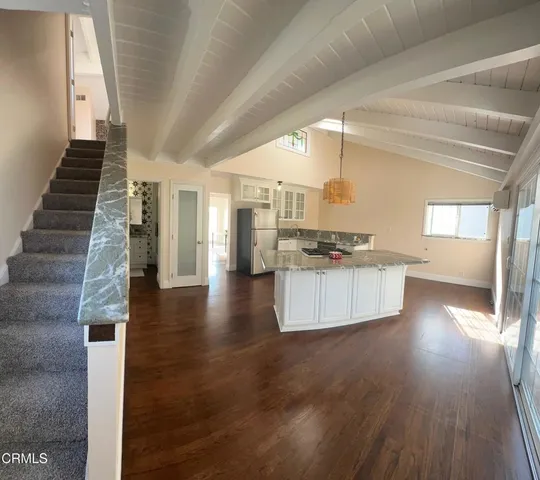 a view of kitchen and hall with wooden floor
