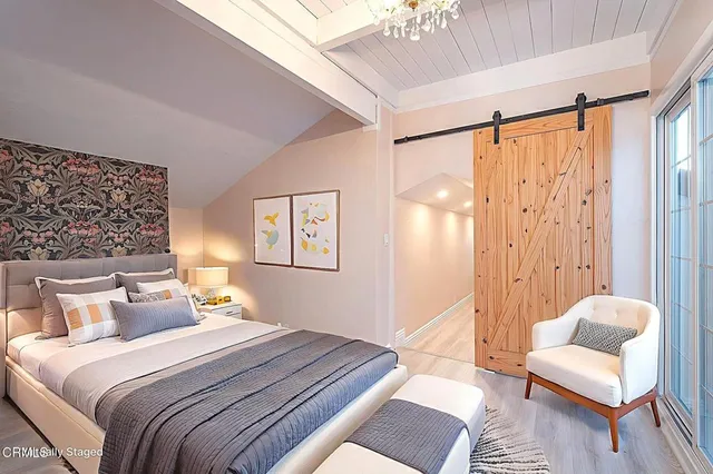 a bedroom with a bed and a couch