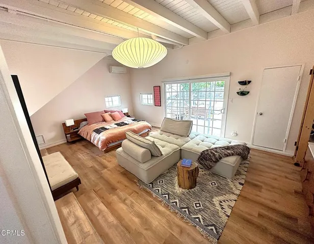 a bedroom with furniture and a wooden floor