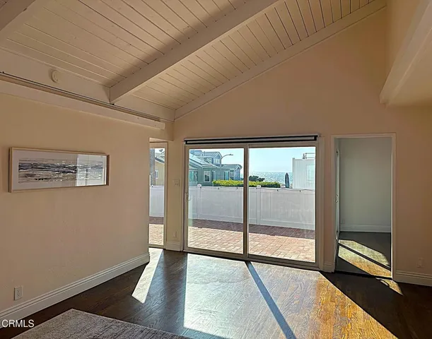 a view of an empty room with glass door