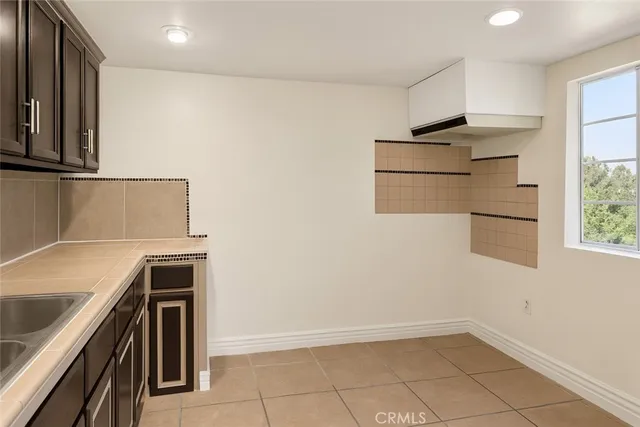 a kitchen with stainless steel appliances a refrigerator and a stove top oven