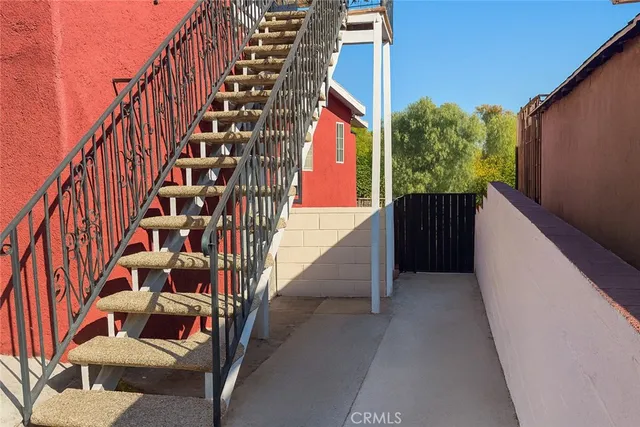 a view of staircase with wooden stairs