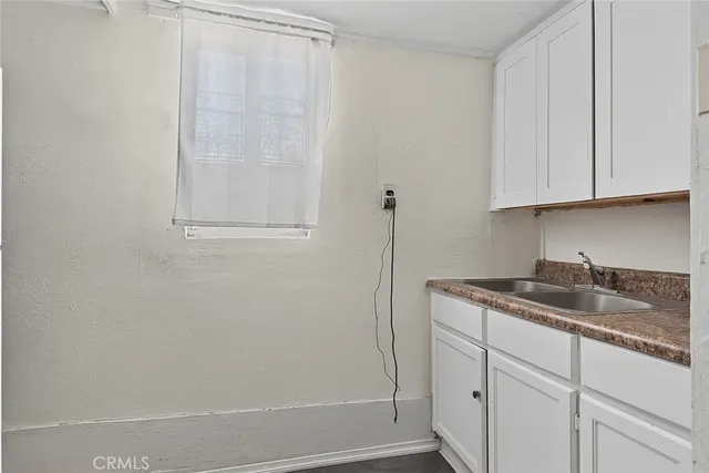 a kitchen with a sink and cabinets