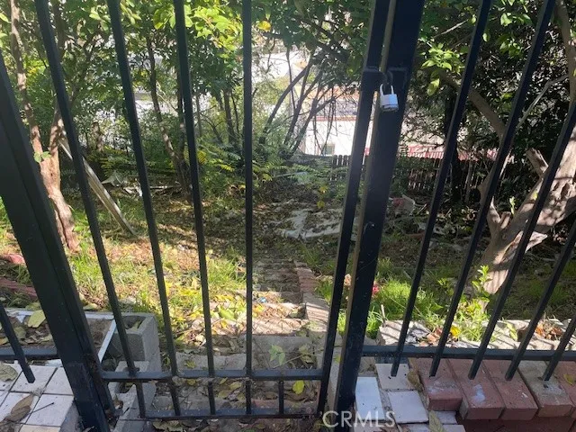 a backyard of a house with lots of plants and tree