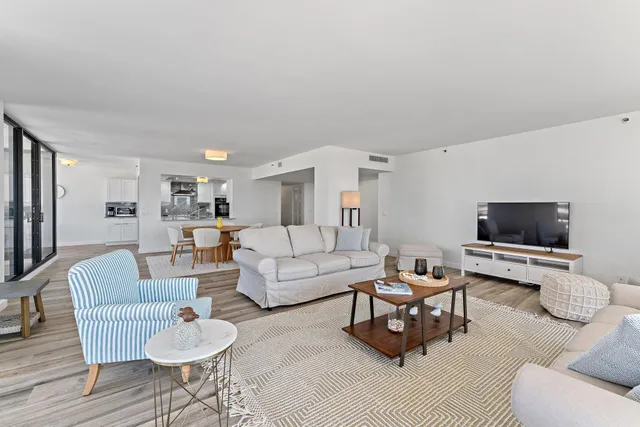 a kitchen with stainless steel appliances granite countertop a stove a sink and a granite counter tops with white cabinets