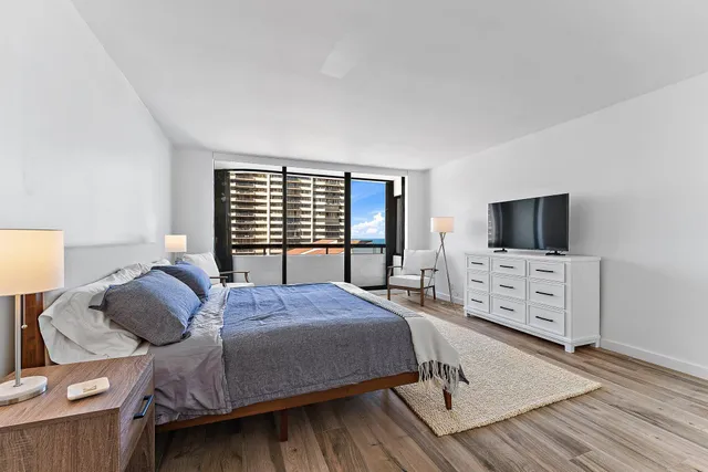 a bedroom with a bed and flat screen tv