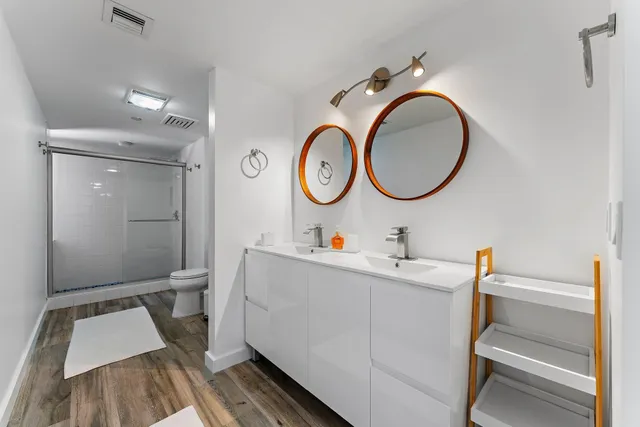 a view of a room with wooden floor and a bathroom