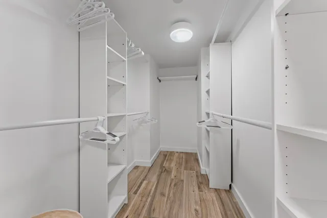 a large bedroom with a bed and a large window