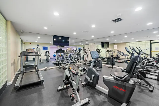 a living room with furniture a table and large windows