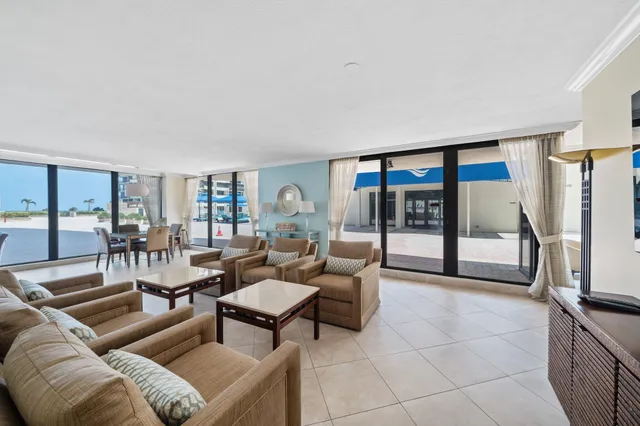 a living room with lots of furniture and view of kitchen