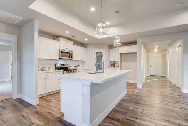 a spacious bathroom with a double vanity sink and mirror