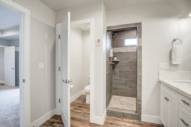 a view of an empty room and chandelier fan