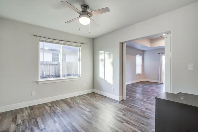 a view of empty room with wooden floor