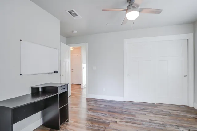a view of a house with a yard and sitting area