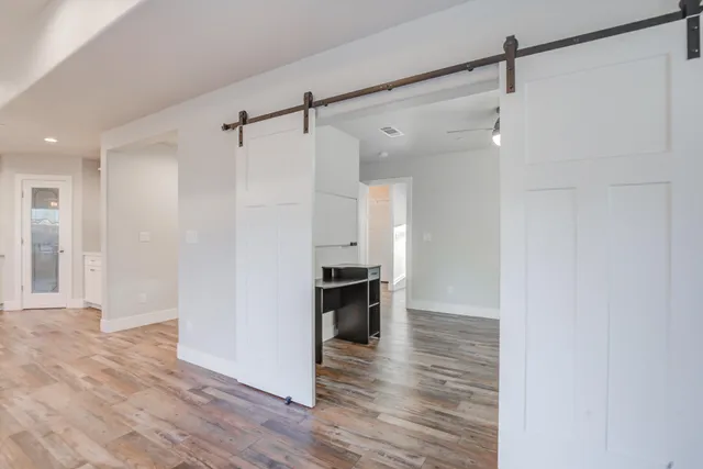 a view of a livingroom with furniture and natural light