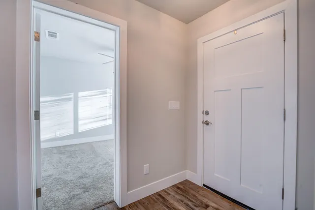 an aerial view of ocean and residential houses with outdoor space