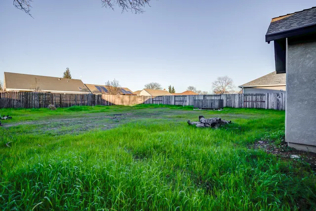 an aerial view of residential houses with outdoor space and river