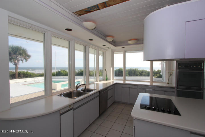 10 Jimmy Mark Place St. Augustine, FL 32080 - Photo 4 of 8 a kitchen with a sink a counter top space and a stove top oven
