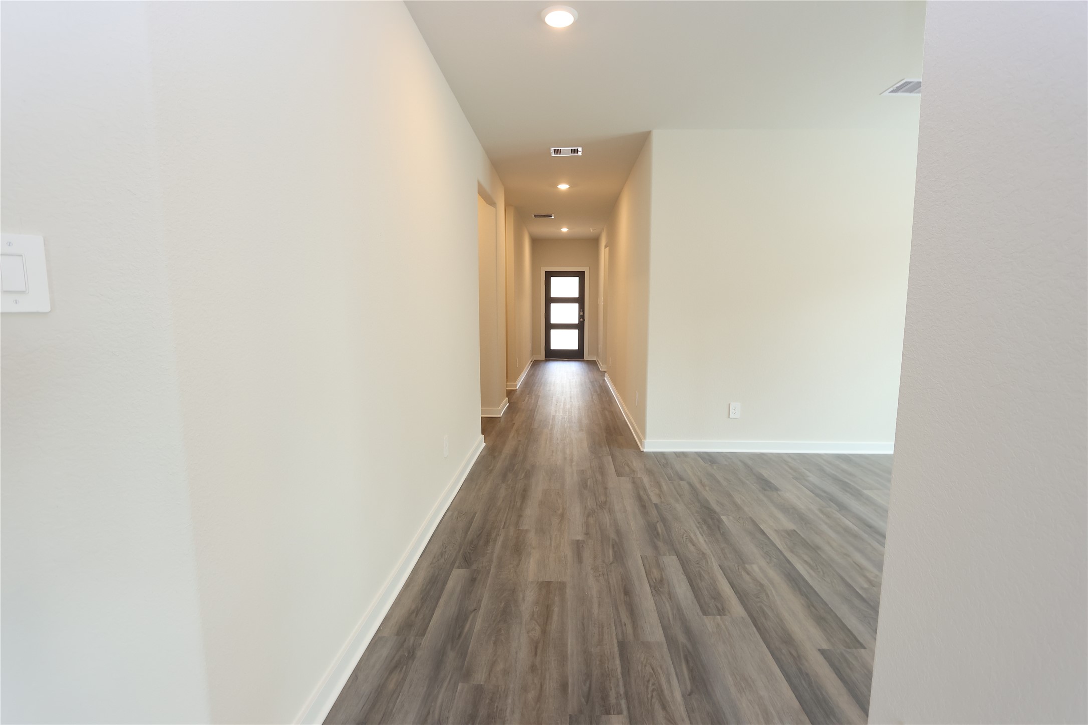 1480 Waggoner Rnch Trail Conroe, TX 77301 - Photo 2 of 18 a view of a hallway with wooden floor