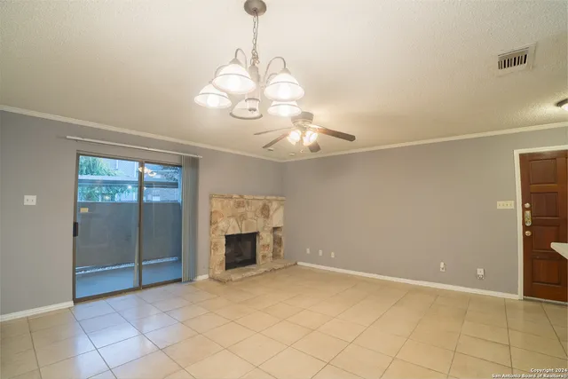a view of an empty room with a fireplace