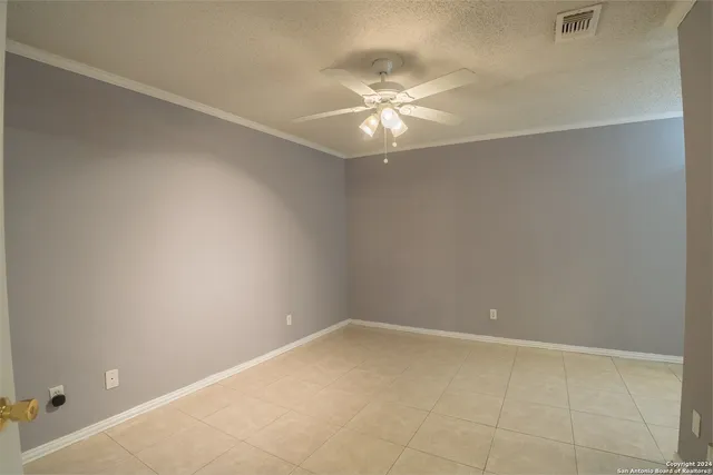 a view of an empty room with a fan