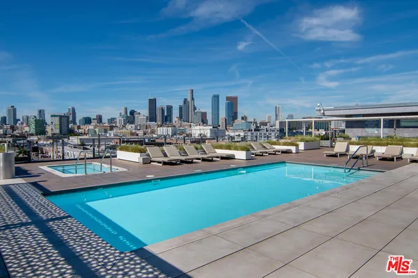 a view of a swimming pool with outdoor seating