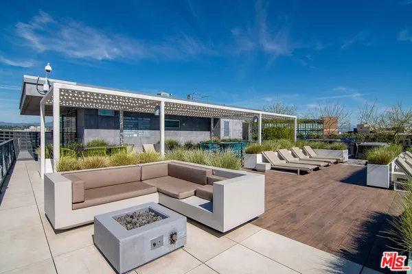 a view of a patio with couches and potted plants