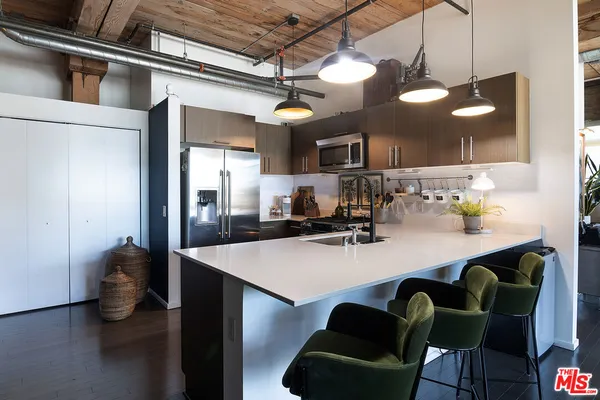 a kitchen with a dining table chairs sink and cabinets