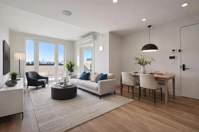 a living room with furniture potted plant a sink and a window