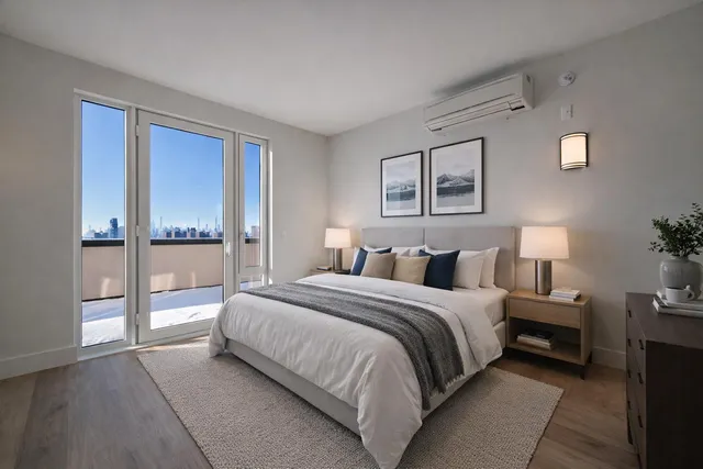 a spacious bedroom with a bed and a lamp