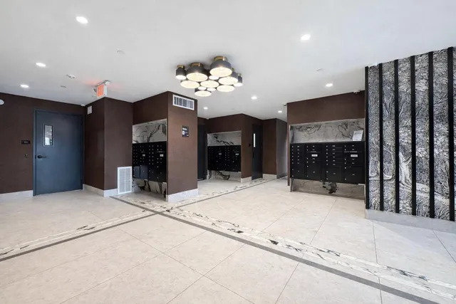 a large kitchen with kitchen island granite countertop a refrigerator and a stove top oven