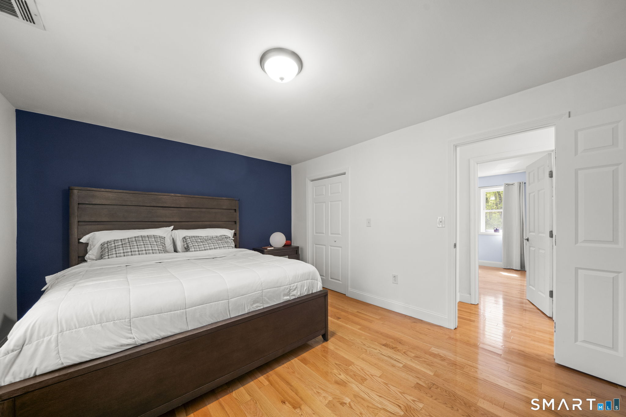 1118 Spindle Hill Road Wolcott, CT 06716 - Photo 19 of 38 a bedroom with a bed and wooden floor