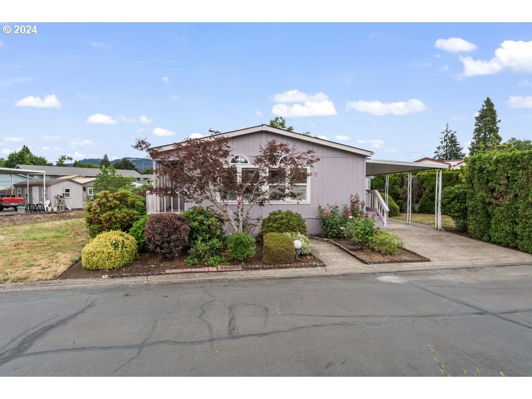 2150 Laura Street, Unit 212 Springfield, OR 97477 - Photo 1 of 37 a front view of a house with a yard and potted plants