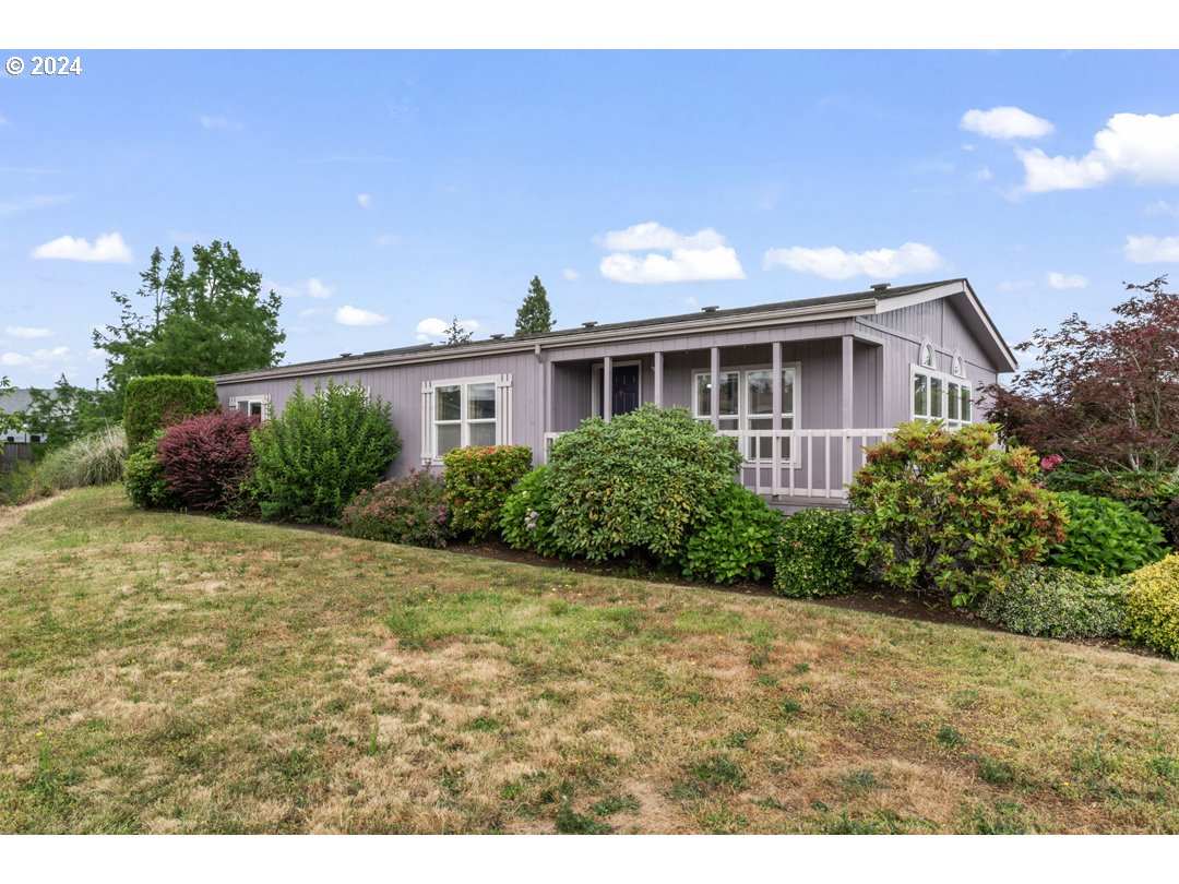 2150 Laura Street, Unit 212 Springfield, OR 97477 - Photo 2 of 37 a front view of a house with garden