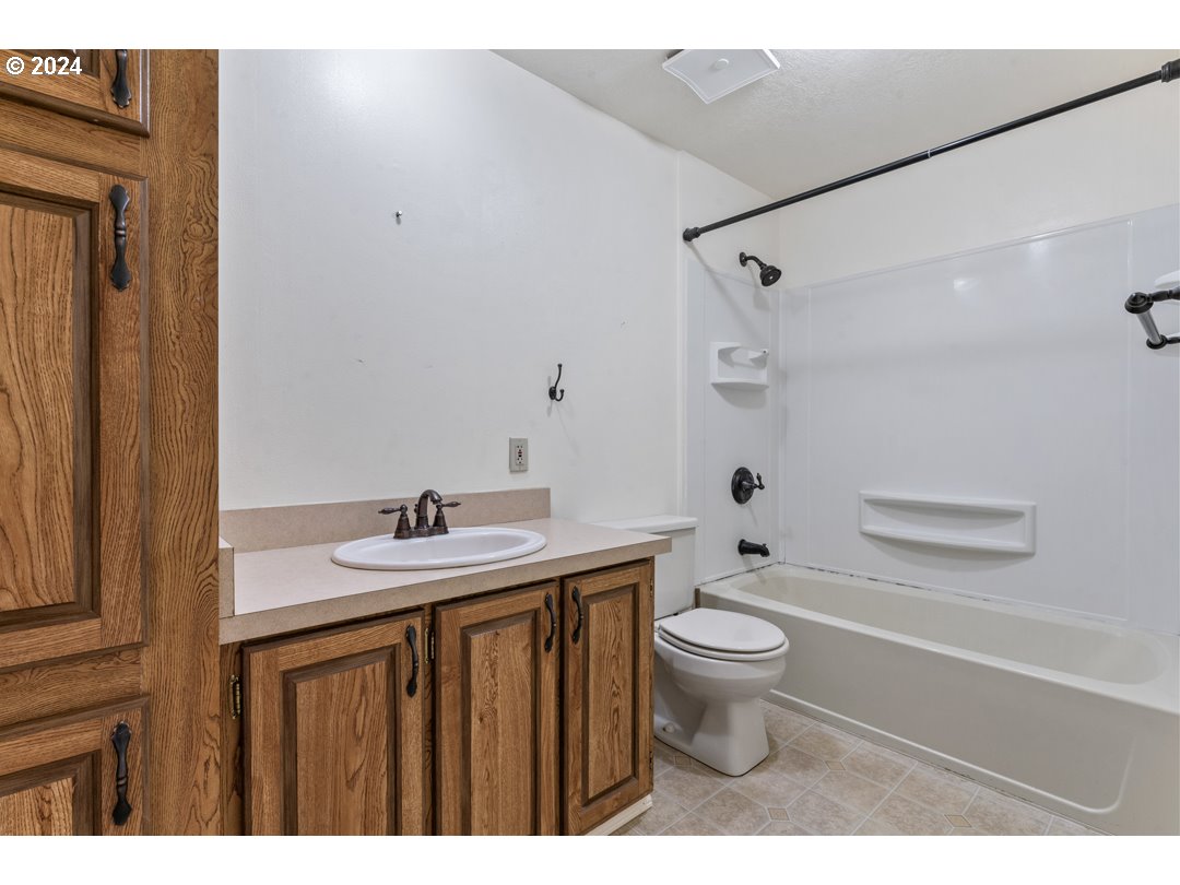 2150 Laura Street, Unit 212 Springfield, OR 97477 - Photo 25 of 37 a bathroom with a sink a toilet and shower