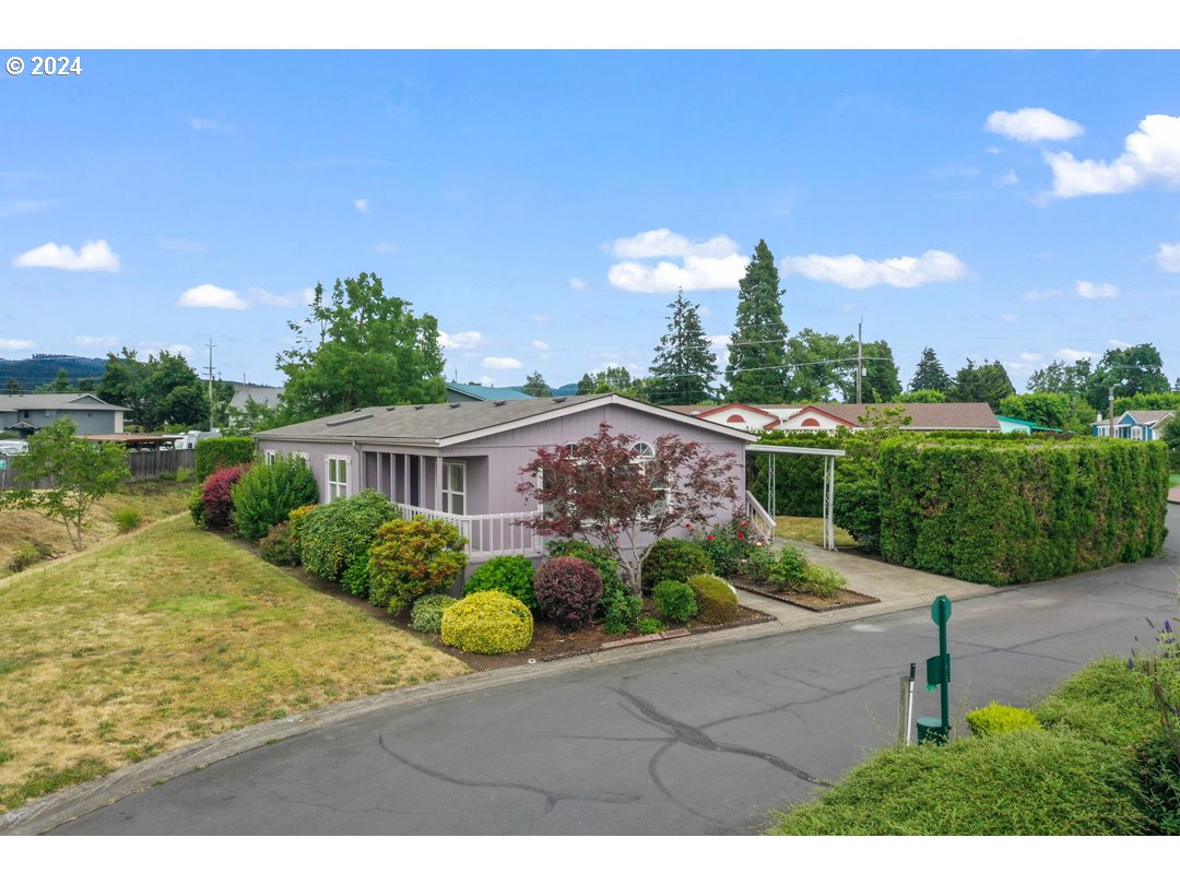 2150 Laura Street, Unit 212 Springfield, OR 97477 - Photo 28 of 37 a view of a house with a yard and potted plants