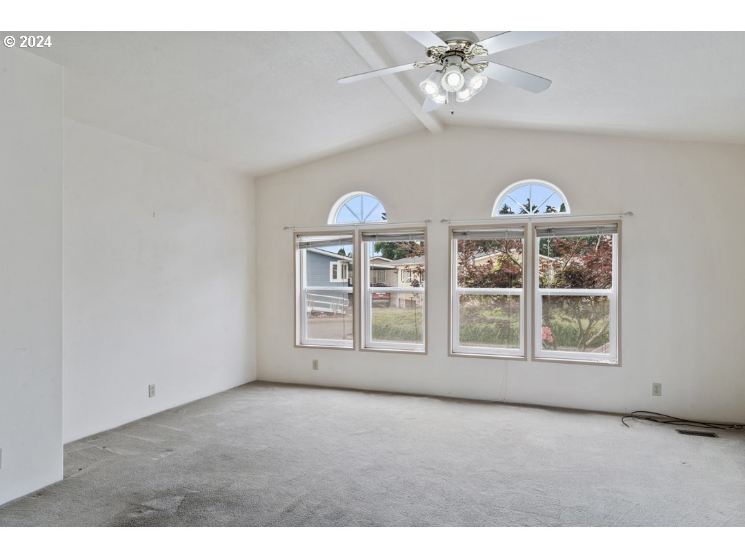 2150 Laura Street, Unit 212 Springfield, OR 97477 - Photo 7 of 37 an empty room with windows and ceiling fan