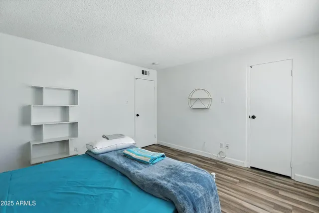 a bedroom with a bed and cabinets