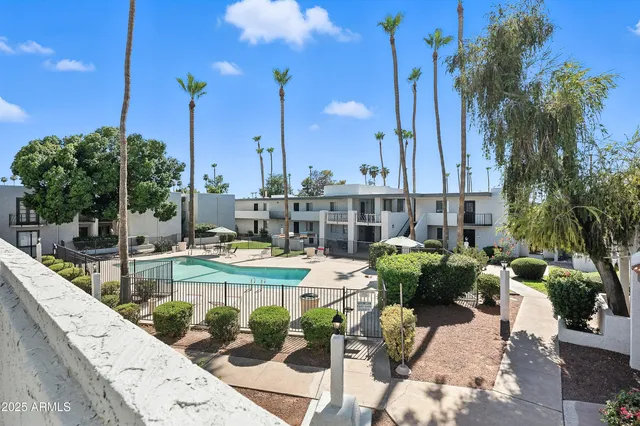 a view of a swimming pool with outdoor seating