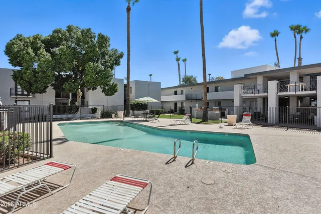 a house view with a sitting space fire pit and outdoor space