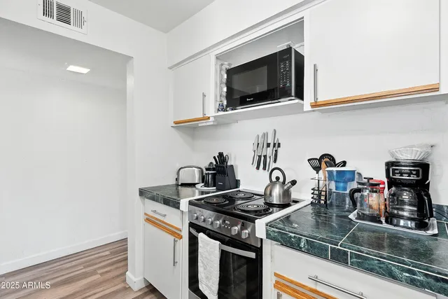 a kitchen with a stove and a microwave