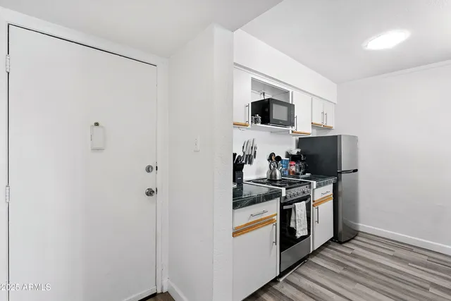a kitchen with stainless steel appliances granite countertop a stove and a refrigerator