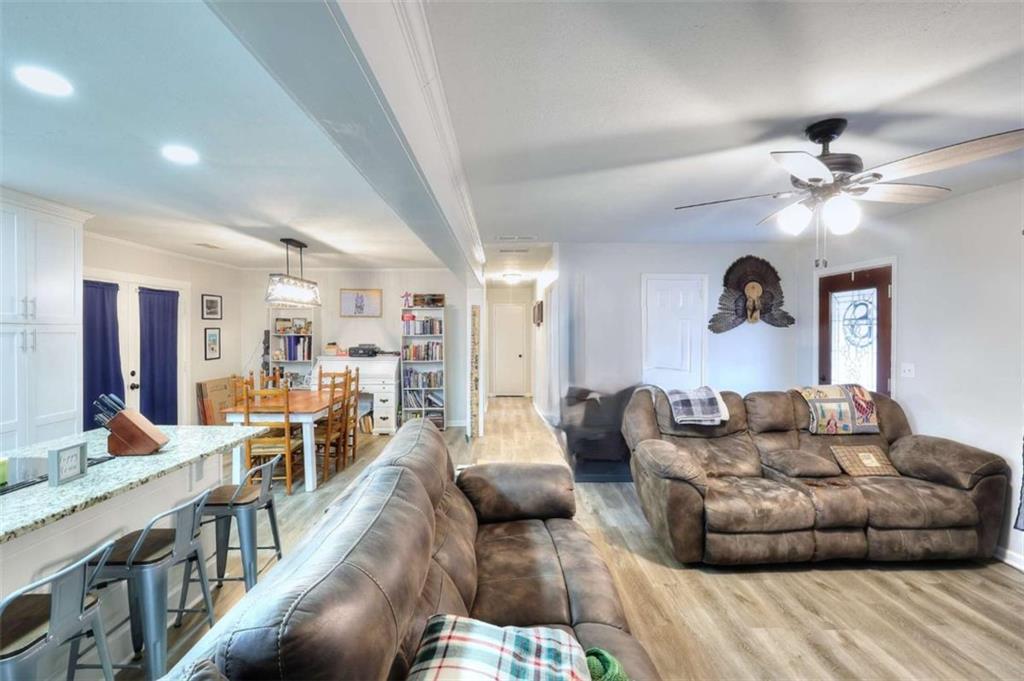 4455 Jersey Walnut Grove Road Covington, GA 30014 - Photo 11 of 28 a living room with furniture and a chandelier