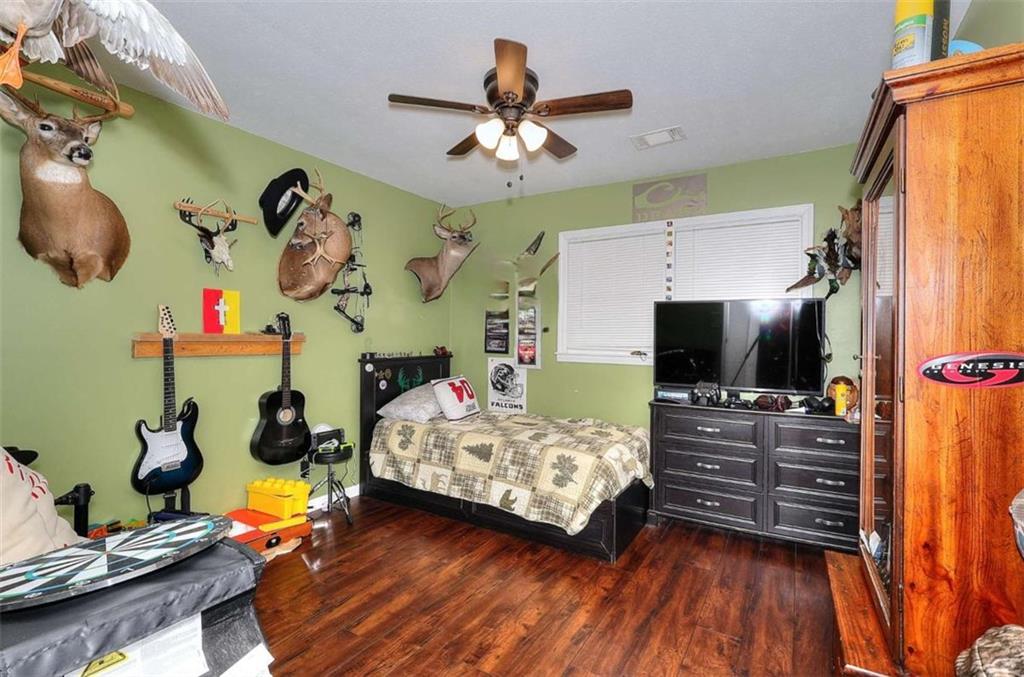 4455 Jersey Walnut Grove Road Covington, GA 30014 - Photo 16 of 28 a bedroom with furniture and a flat screen tv